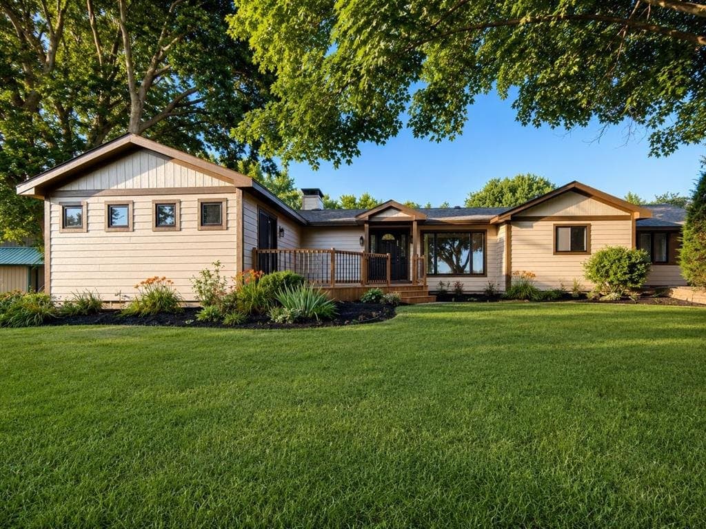 The same ranch house with new lap siding, replacement windows and a rebuilt deck